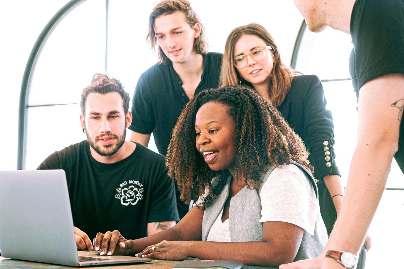 group of local seo experts working together on local keyword research on computer in office